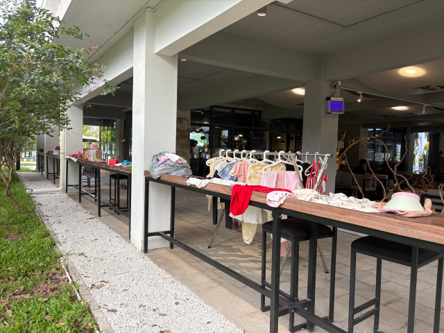 Donated second-hand items in the event lined up on four long tables in a cafe in Nansha.