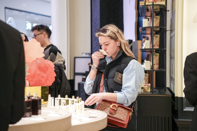International shopper trying perfume in Guangzhou.