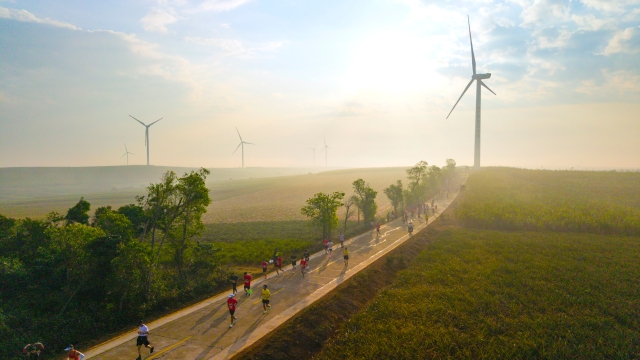Runners race on a country road.&nbsp;